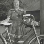1960 Cindy Denison with bicycle at LV Leader sign